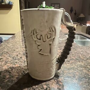 Handmade pottery coffee cup with deer motif and braided handle. One of a kind